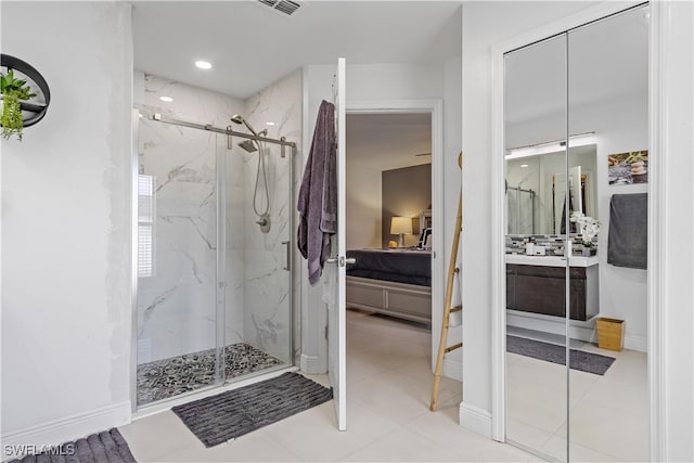 bathroom featuring tile patterned floors, vanity, and an enclosed shower