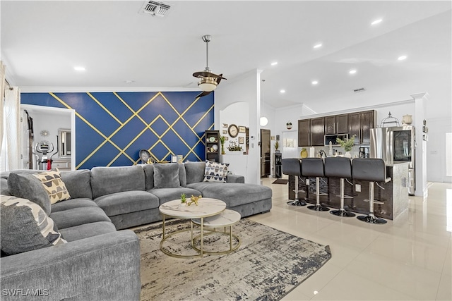 living room with light tile patterned floors and ornamental molding