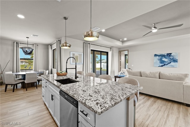 kitchen featuring white cabinetry, dishwasher, sink, a healthy amount of sunlight, and pendant lighting