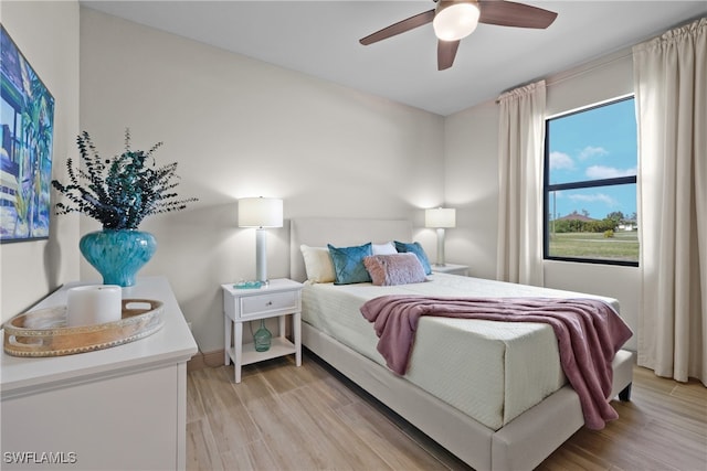 bedroom with ceiling fan and light wood-type flooring