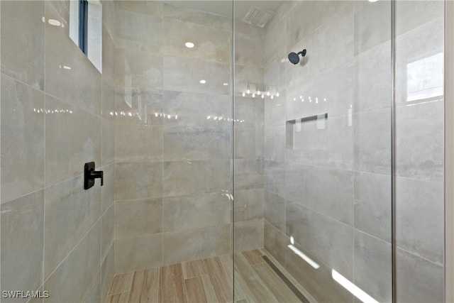 bathroom with tiled shower