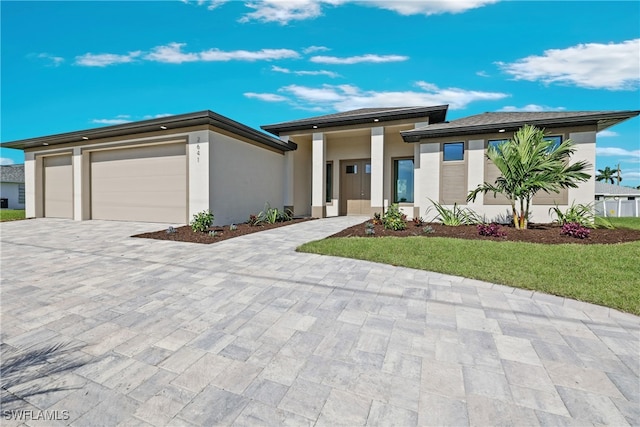 prairie-style house with a front yard and a garage