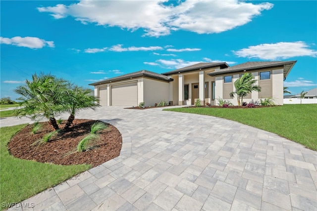 prairie-style house featuring a garage and a front yard