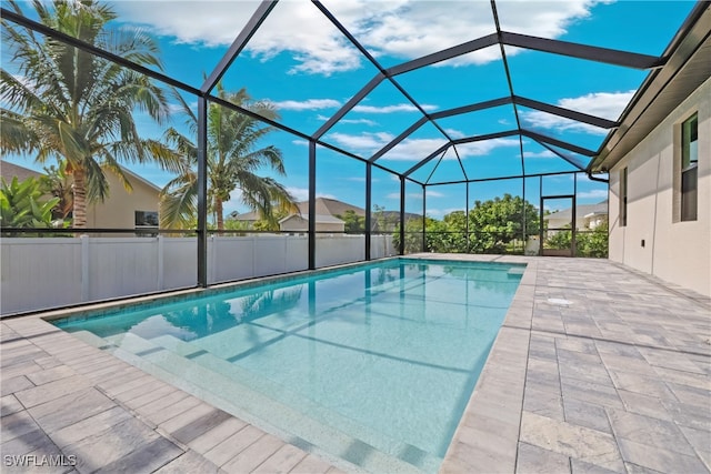 view of pool with a patio area and a lanai