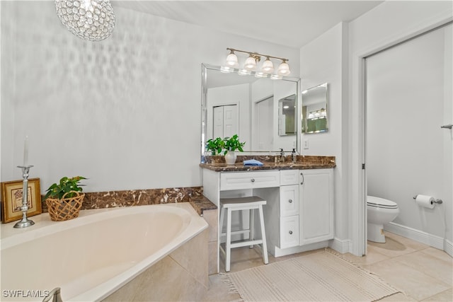 full bath featuring tile patterned flooring, a garden tub, vanity, and toilet