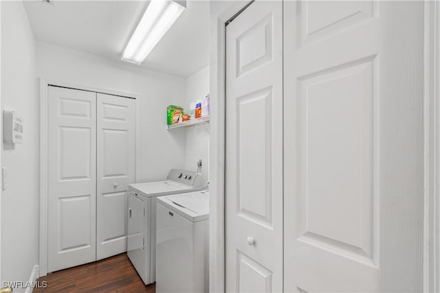 laundry area with laundry area, dark wood-type flooring, and washing machine and clothes dryer