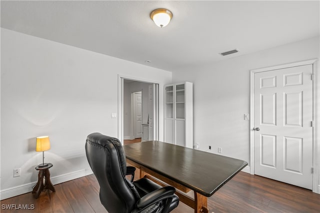 home office featuring dark wood-style floors, visible vents, and baseboards