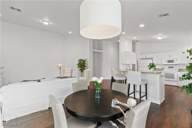 dining area with vaulted ceiling, visible vents, dark wood finished floors, and recessed lighting