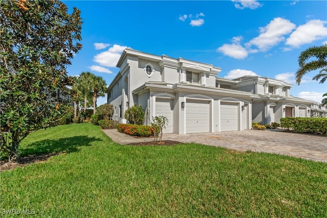 view of side of home featuring a lawn, decorative driveway, and stucco siding