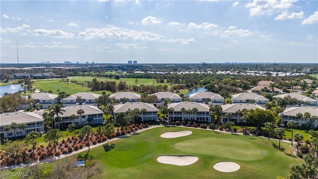 aerial view with a residential view, a water view, and golf course view