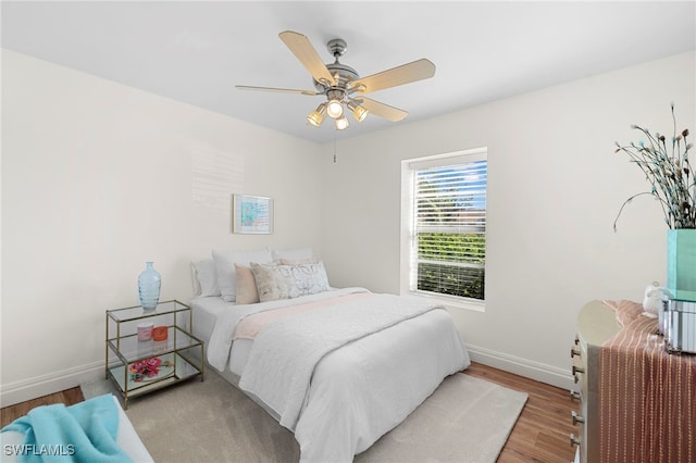 bedroom with light hardwood / wood-style flooring and ceiling fan