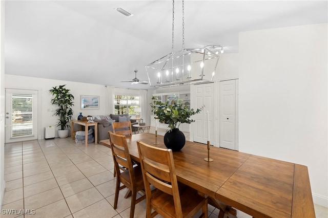 dining area featuring ceiling fan with notable chandelier and light tile patterned floors