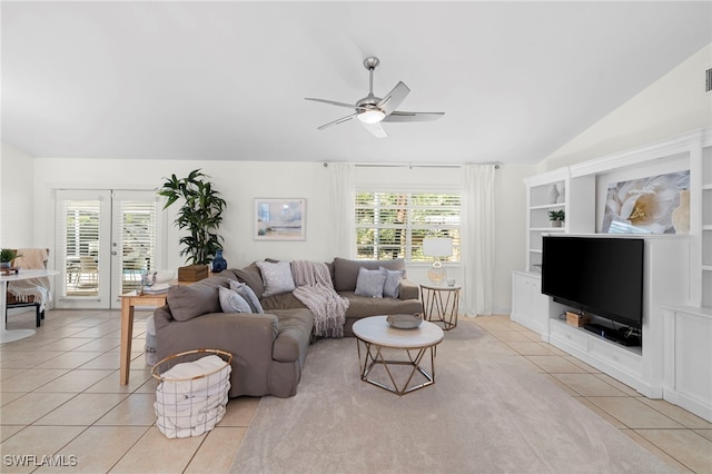 living room with ceiling fan, light tile patterned floors, french doors, and lofted ceiling