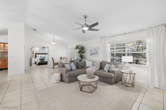 tiled living room with ceiling fan and lofted ceiling