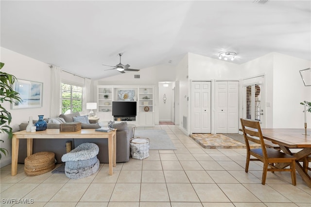 living room with built in shelves, light tile patterned floors, vaulted ceiling, and ceiling fan