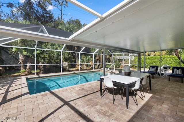 view of pool featuring glass enclosure and a patio