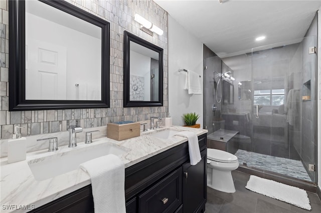 bathroom with vanity, tile walls, tile patterned flooring, toilet, and a shower with shower door