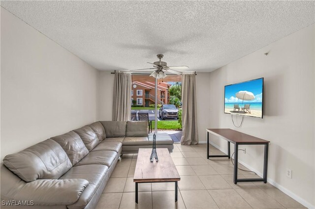 tiled living room featuring ceiling fan and a textured ceiling