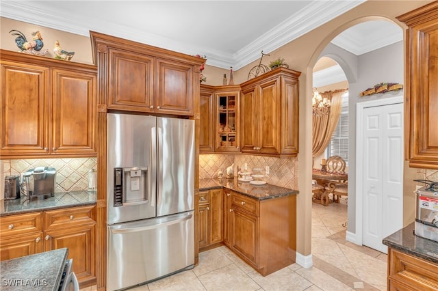 kitchen with stainless steel fridge with ice dispenser, light tile patterned floors, and ornamental molding