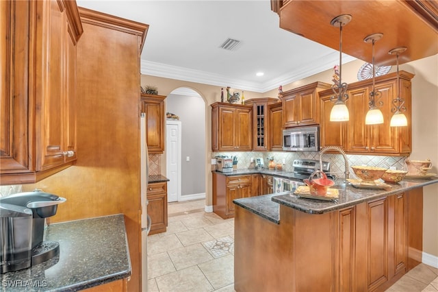 kitchen featuring decorative light fixtures, kitchen peninsula, appliances with stainless steel finishes, and dark stone counters