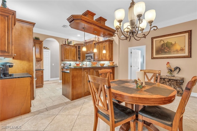 tiled dining space featuring a notable chandelier and ornamental molding