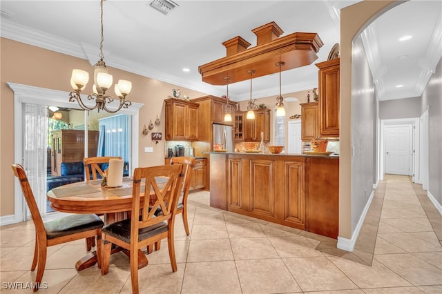 tiled dining space with crown molding and an inviting chandelier