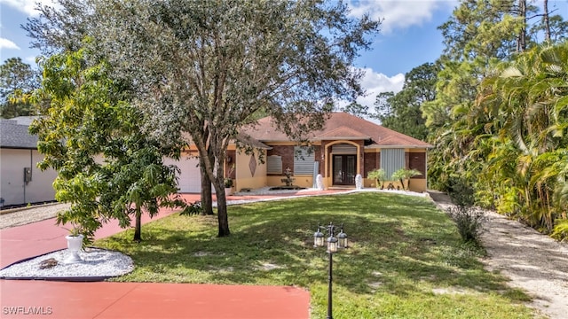 view of front of home with a garage and a front yard