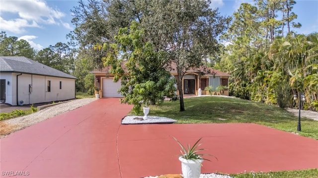 view of front of house featuring a garage and a front yard