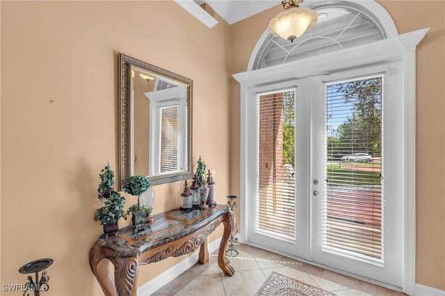 entryway with french doors and light tile patterned flooring