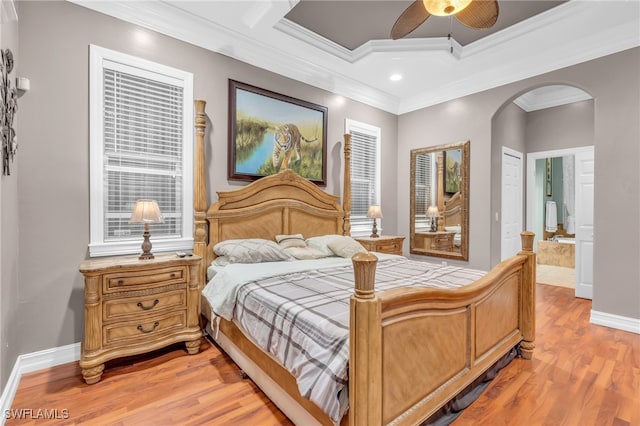 bedroom featuring a closet, hardwood / wood-style flooring, ceiling fan, and crown molding