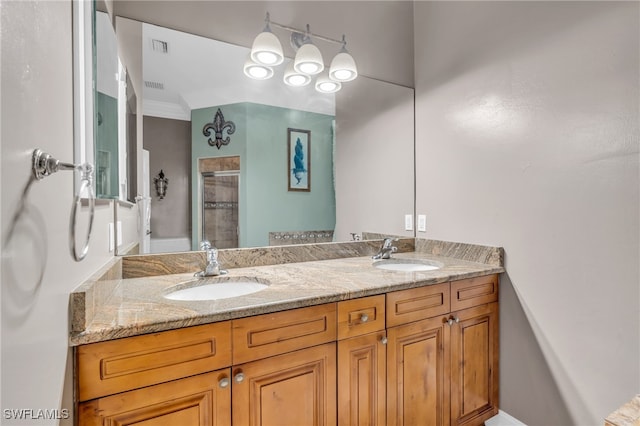 bathroom featuring vanity, an enclosed shower, and ornamental molding