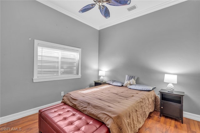 bedroom with ceiling fan, wood-type flooring, and ornamental molding