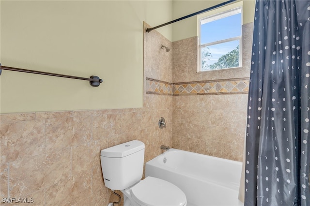 bathroom featuring toilet, tile walls, and shower / tub combo with curtain