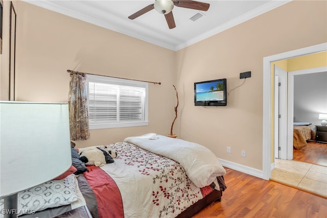 bedroom featuring ceiling fan, hardwood / wood-style floors, and ornamental molding