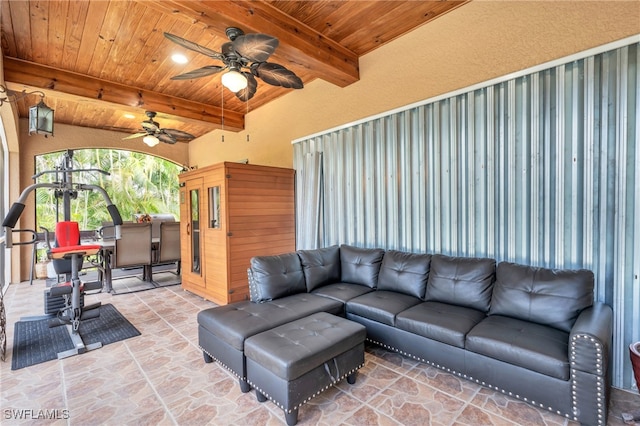 living room with beamed ceiling, ceiling fan, and wooden ceiling