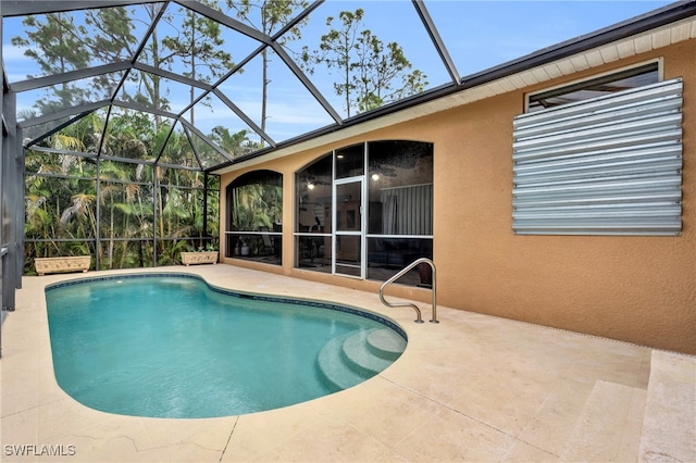 view of pool featuring a patio area and glass enclosure