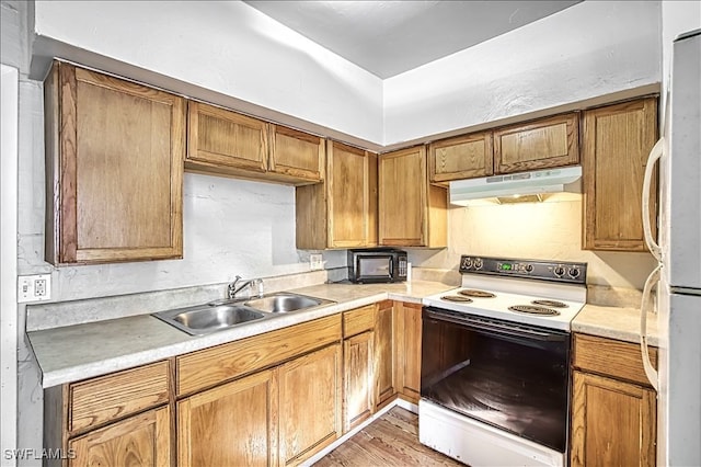 kitchen featuring white range with electric cooktop, light hardwood / wood-style floors, sink, and fridge