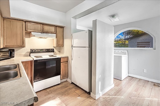 kitchen with light wood-type flooring, washer / dryer, white appliances, and sink