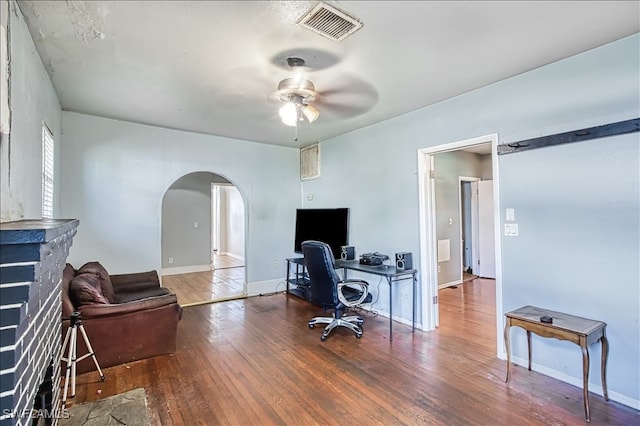 office area with ceiling fan and dark hardwood / wood-style flooring