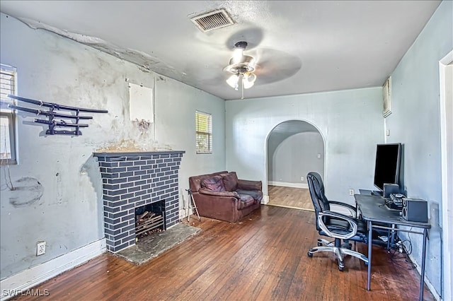 home office featuring ceiling fan and dark wood-type flooring