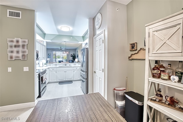 corridor with sink and light hardwood / wood-style flooring