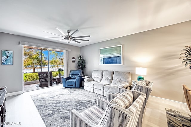 living room with light wood-type flooring and ceiling fan