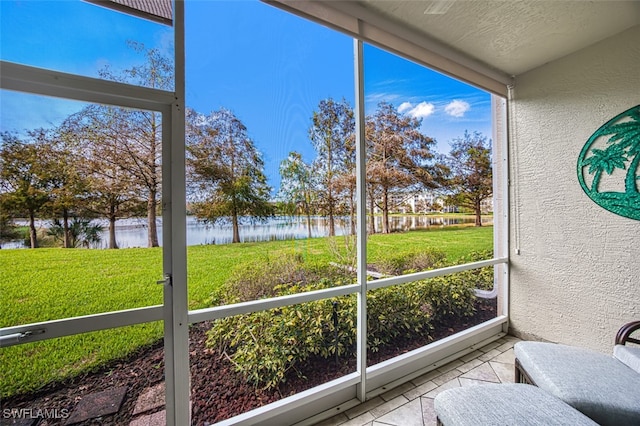 sunroom featuring a water view and a wealth of natural light