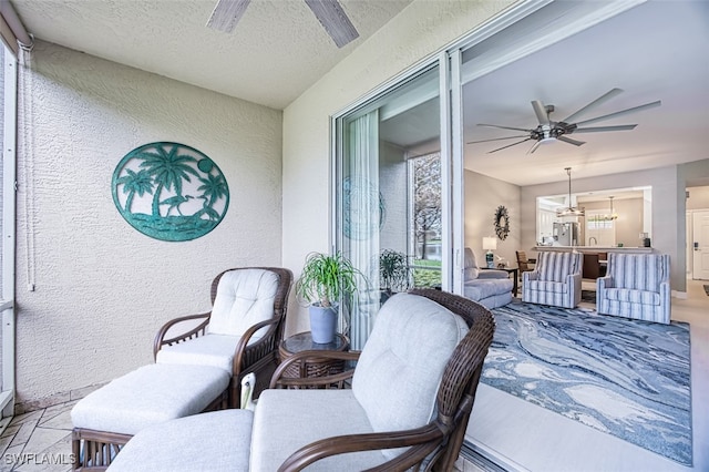 view of patio featuring ceiling fan and exterior bar