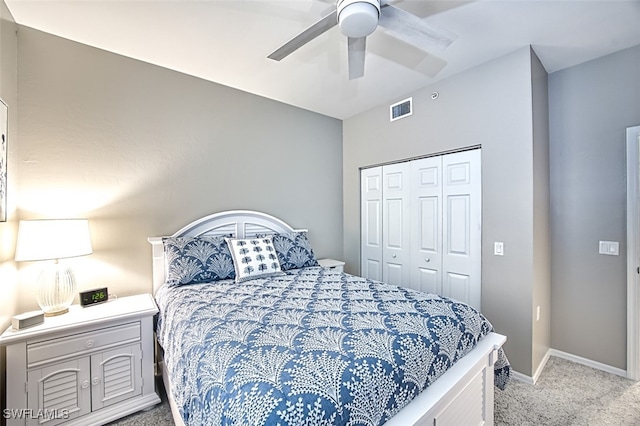 carpeted bedroom featuring ceiling fan and a closet