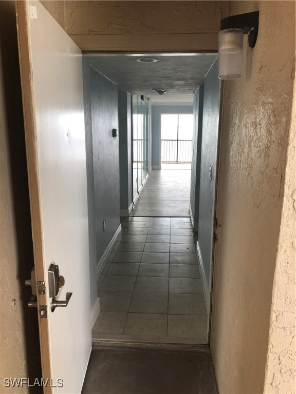 corridor with dark tile patterned floors