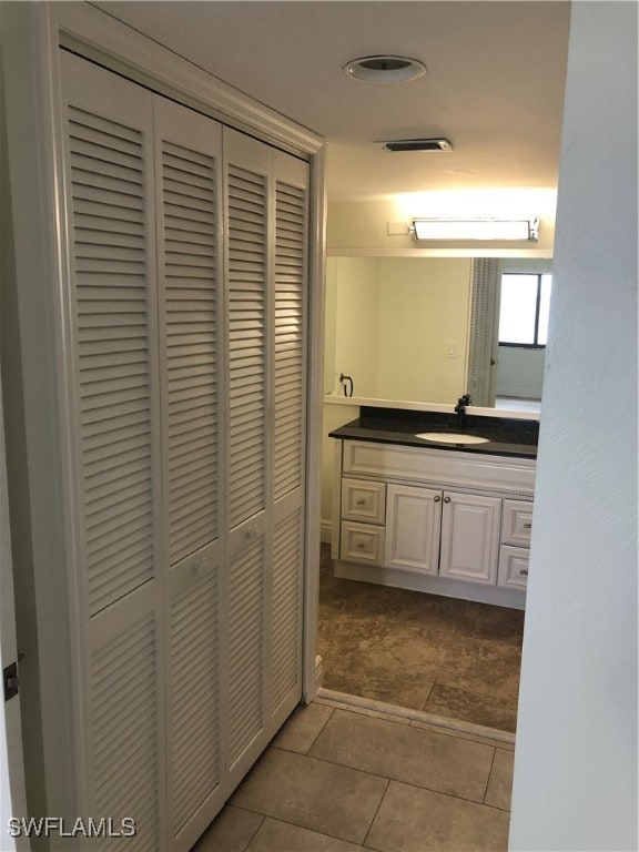 bathroom with tile patterned flooring and vanity