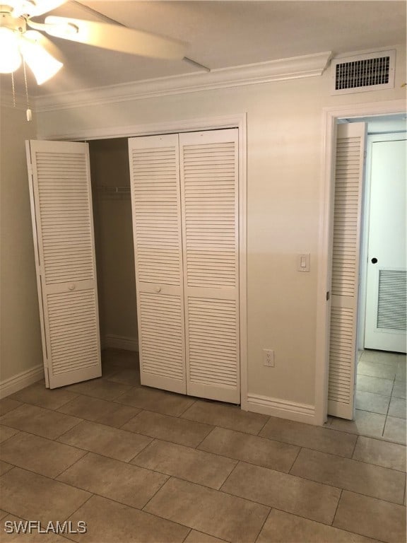 unfurnished bedroom featuring tile patterned flooring, ceiling fan, and ornamental molding