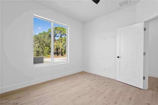 unfurnished room with light wood-type flooring