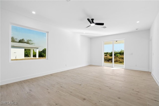 empty room featuring light hardwood / wood-style floors, plenty of natural light, and ceiling fan